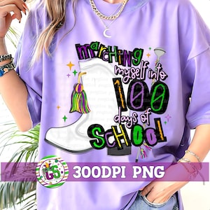 May include: A light purple t-shirt with the text "Marching myself into 100 days of school" and a white boot graphic. The design includes green, purple, and yellow accents, and a logo that says "300DPI PNG".