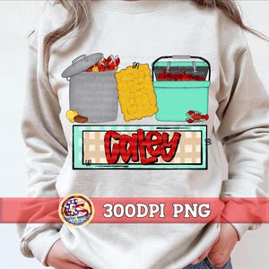 May include: A graphic design featuring a gray container, a yellow food item, and a teal cooler, all filled with red crawfish. The word "Caley" is written in red with a black outline. The design is on a light gray sweatshirt.