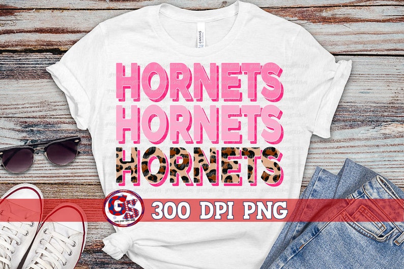 May include: White t-shirt with the words "Hornets" repeated three times in pink and black with a leopard print design. The text "300 DPI PNG" is also included on the shirt.