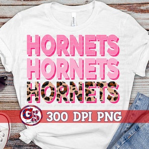 May include: White t-shirt with the words "Hornets" repeated three times in pink and black with a leopard print design. The text "300 DPI PNG" is also included on the shirt.