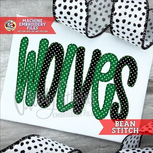 May include: White background with the word "Wolves" in green and black polka dot lettering. The image includes the text "MACHINE EMBROIDERY FILES" and "BEAN STITCH". Black and white polka dot ribbon is in the background.
