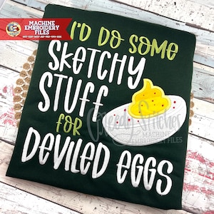 May include: Dark green t-shirt with the text "I'd do some sketchy stuff for deviled eggs" in white and yellow. A deviled egg graphic is on the right side of the shirt. The shirt has a Machine Embroidery Files logo.