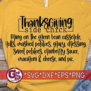 May include: Mustard yellow t-shirt with the text "Thanksgiving side chick" in black. The shirt lists Thanksgiving foods like green bean casserole, mashed potatoes, and pie. Sunglasses and jeans are visible.
