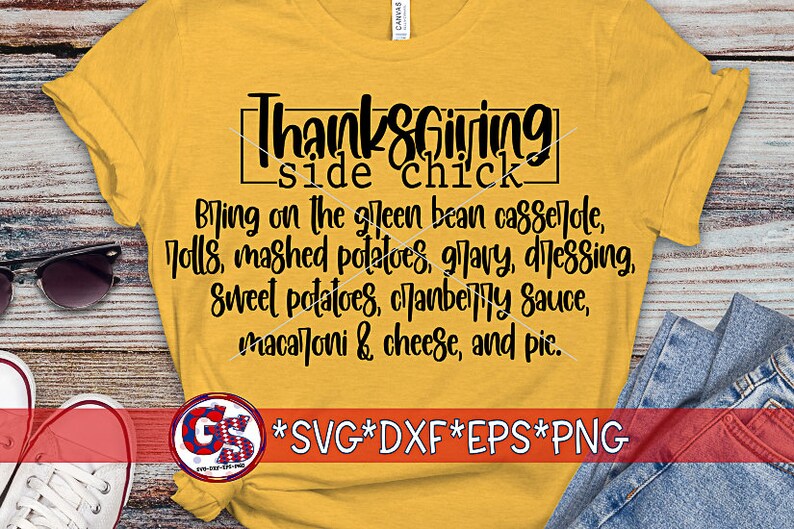 May include: Mustard yellow t-shirt with the text "Thanksgiving side chick" in black. The shirt lists Thanksgiving foods like green bean casserole, mashed potatoes, and pie. Sunglasses and jeans are visible.