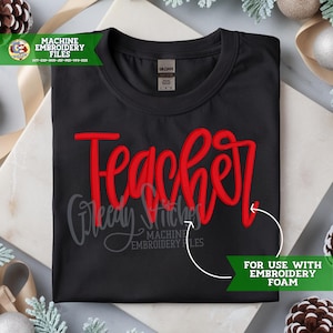 May include: Black t-shirt with the word "Teacher" in red script. The shirt also features the text "Greedy Stitches Machine Embroidery Files" in gray. A green banner indicates the shirt is "For Use With Embroidery Foam."