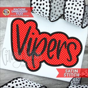 May include: A red and white polka-dotted "Vipers" design with a black outline, perfect for machine embroidery. The design includes the text "Satin Stitch" and "Machine Embroidery Files". A black and white polka dot ribbon is in the background.