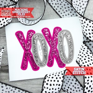 May include: Embroidered design of the letters XOXO in pink and silver glitter with a satin stitch. The design is on a white background.