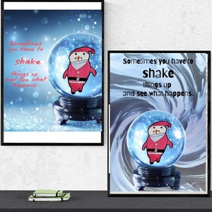 May include: Two framed art prints featuring a snow globe with a snowman figure. The snow globe is set against a blue background with falling snow. The text "Sometimes you have to shake things up and see what happens" is displayed on both prints.