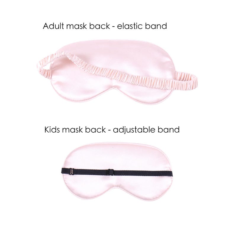May include: Two pink satin sleep masks with different back straps. The top mask has an elastic band, and the bottom mask has an adjustable strap.