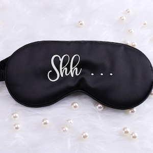 May include: Black sleep mask with white text that says "Shh..."