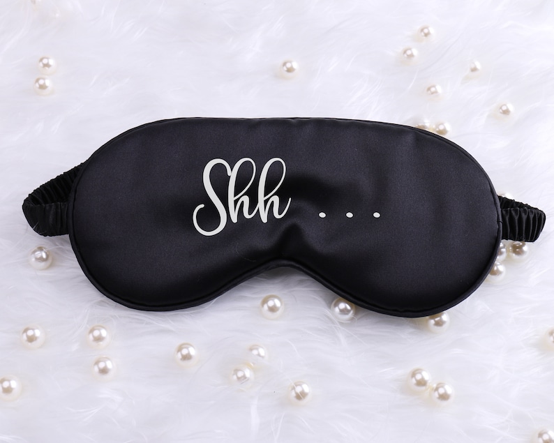 May include: Black sleep mask with white text that says "Shh..."