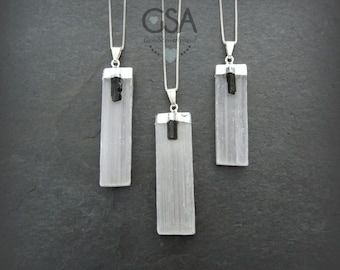 May include: Three silver necklaces with white selenite crystal pendants and black tourmaline accents. The pendants are rectangular and have a smooth, polished finish.