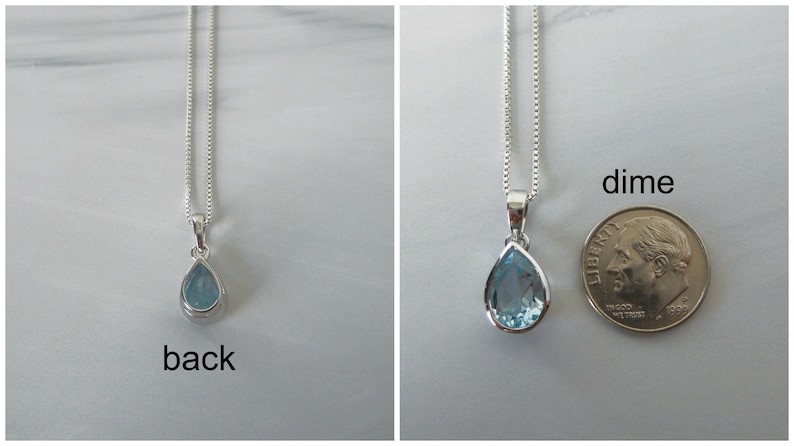 May include: A teardrop-shaped pendant necklace with a light blue gemstone. The pendant is about the size of a dime.