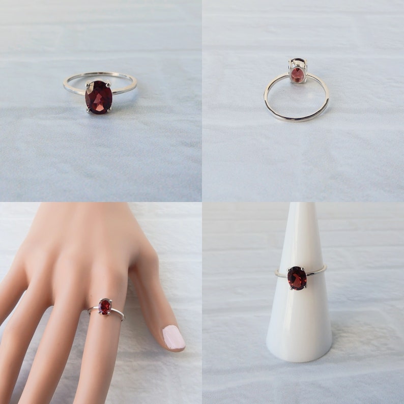Pu&ograve; includere: Un anello d'argento con una pietra ovale rossa. L'anello &egrave; mostrato su un dito, su un supporto bianco e su uno sfondo bianco.