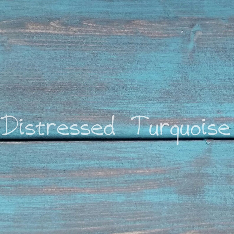 May include: Distressed turquoise wood plank with the text "Distressed Turquoise" written in white paint.