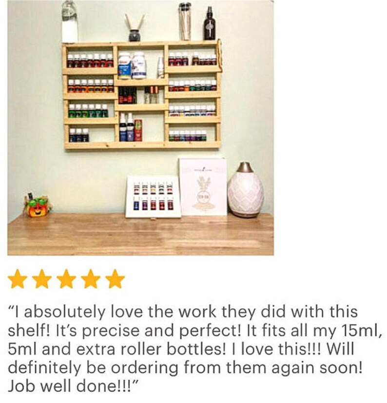 May include: A wooden wall-mounted shelf with multiple shelves for storing essential oil bottles. The shelf is filled with various sized bottles, including roller bottles. The shelf is made of natural wood and has a rustic look.
