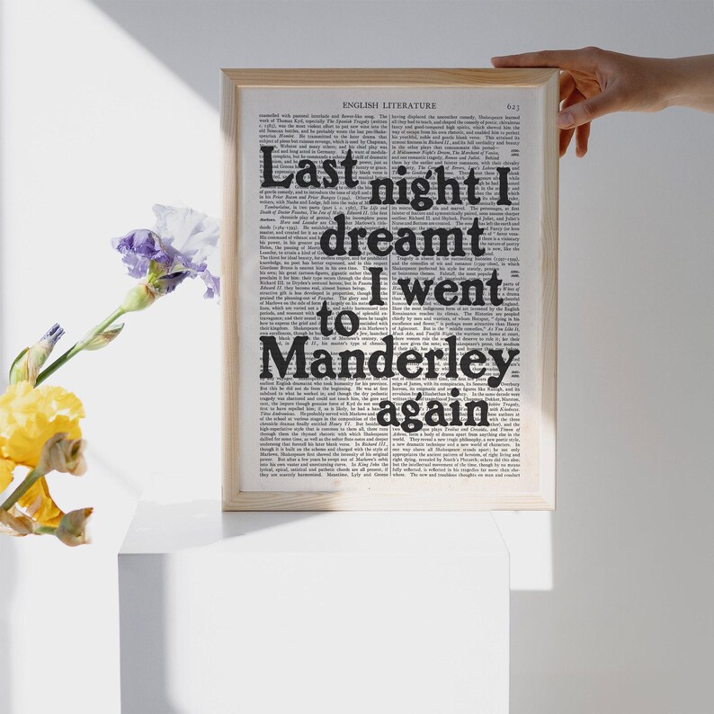 May include: A framed print with a black and white background featuring the text "Last night I dreamt I went to Manderley again".