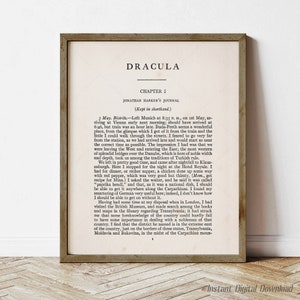 May include: A framed print of a page from the book Dracula by Bram Stoker. The page features the first chapter of the book, titled "Chapter I", and includes the first few paragraphs of the story. The text is in black and white, and the frame is a simple, brown wood frame.