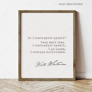 May include: A framed print featuring a quote by Walt Whitman: "Do I contradict myself? Very well then I contradict myself, I am large, I contain multitudes." The text is in a serif font on a cream background, with a brown wooden frame.