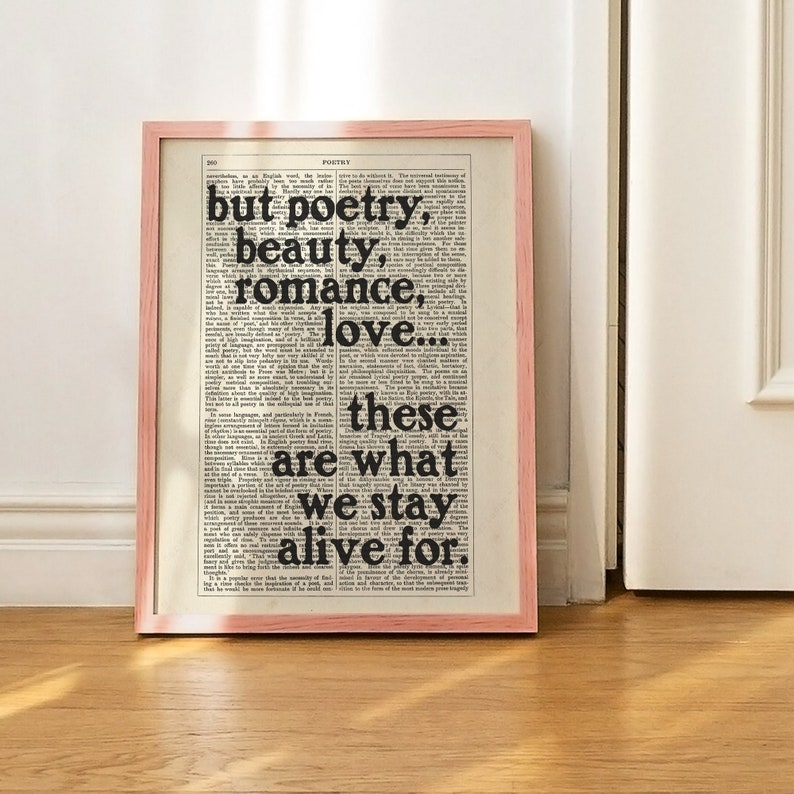 May include: A framed print with a black and white text overlay on a vintage dictionary page. The text reads "but poetry, beauty, romance, love... these are what we stay alive for."