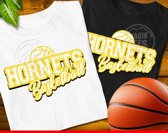 May include: A white t-shirt and a black t-shirt, each featuring a graphic with the text "HORNETS Basketball" in yellow block letters with a black outline, accompanied by a yellow basketball illustration, alongside a standard orange basketball.
