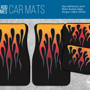 May include: Set of four black car floor mats with a flame design in orange, red, and blue. The mats have black finished edges and a Durgan rubber bottom. "Hot Rod Flames Car Mats" is written at the top of the image.