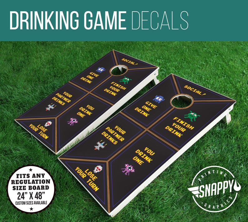 May include: Two black and white regulation size cornhole boards with custom decals. The decals feature a pixelated design with the text "Social!" and phrases like "Give One Drink", "Finish Your Drink", and "Lose Your Turn".
