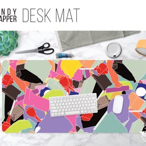 May include: A colorful desk mat with a design of candy wrappers in various colors, including pink, green, yellow, and red. The mat is made of a durable material and is perfect for protecting your desk from scratches and spills. The mat features the text "CANDY WRAPPER DESK MAT".
