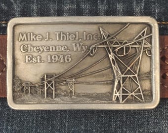 RARE 1986 Mike J Theil Cheyenne WY Est. 1946 Belt Buckle With High Voltage Power Lines Commemorating Utility Industry in 1940's Collectible