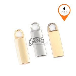 May include: Three metal craft supplies in gold, silver, and gold-tone. Each has a rectangular body with a rounded top and a small loop. The image includes a graphic that says "4 PCS" in an orange location marker.