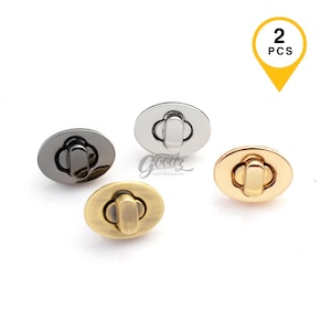 May include: Four oval-shaped purse clasps in various metallic finishes: black, silver, gold, and antique brass. The clasps have a central locking mechanism. A yellow tag in the upper right corner indicates "2 PCS". The clasps are for craft supplies.