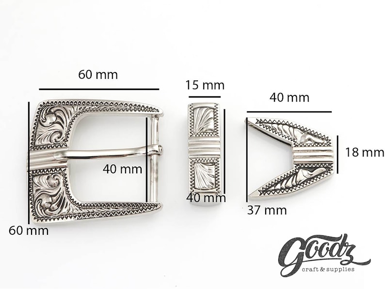 May include: Silver-toned metal belt buckle with an ornate design. The buckle measures 2.36 inches wide and 2.36 inches tall. The buckle is designed to fit a 1.57 inch wide belt.