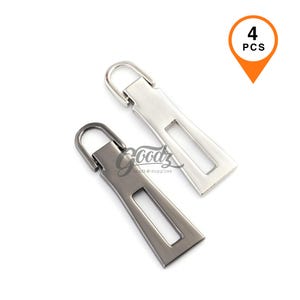 Puede incluir: Dos tiradores de cremallera metálicos, uno plateado y otro gris plomo, con un recorte rectangular y un lazo para la fijación. La imagen incluye una etiqueta naranja que dice "4 PCS". El logotipo de Goodz craft & supplies es visible.