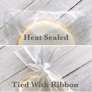 May include: A white cookie with the text "Heat Sealed" is shown in a clear plastic bag. The bag is tied with a white ribbon and the text "Tied With Ribbon" is shown below the cookie.