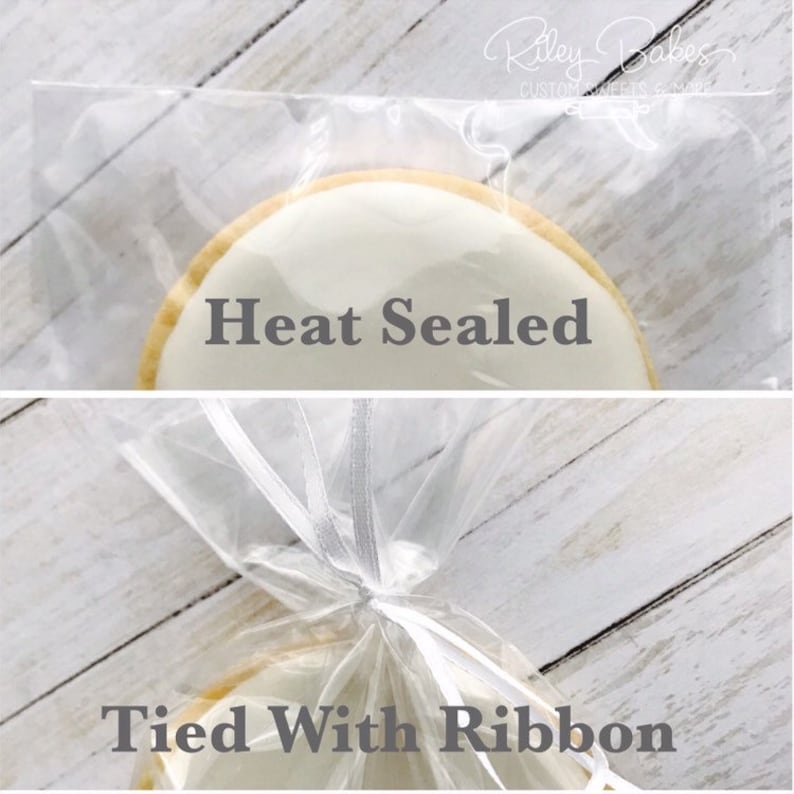 May include: A white cookie with the text "Heat Sealed" is shown in a clear plastic bag. The bag is tied with a white ribbon and the text "Tied With Ribbon" is shown below the cookie.
