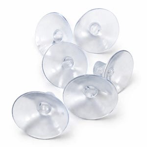 Puede incluir: Un conjunto de ventosas transparentes y claras. Cada ventosa tiene un disco plano y circular con un pequeño botón redondeado en el centro. Las ventosas están hechas de un material transparente y flexible, diseñado para adherirse a superficies lisas.