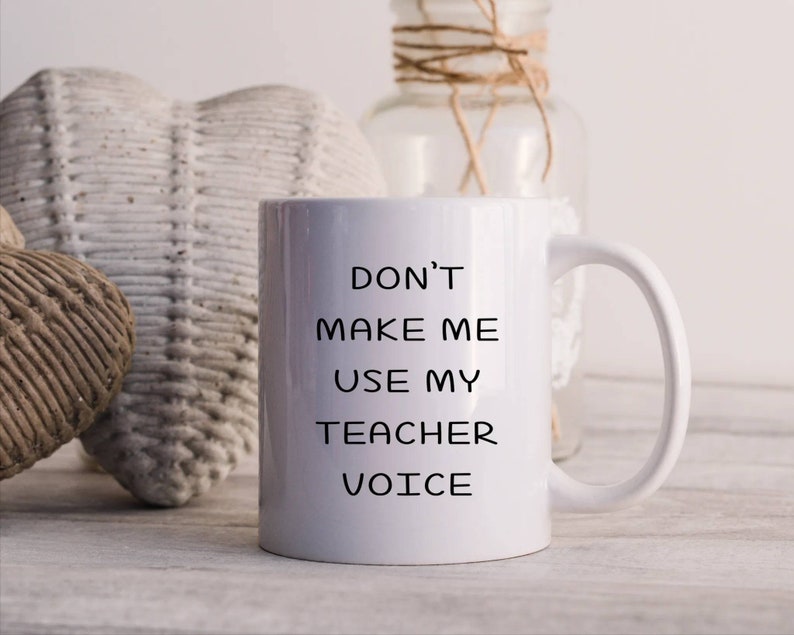 Puede incluir: Taza de caf&eacute; de cer&aacute;mica blanca con texto negro que dice "No me hagas usar mi voz de maestro".