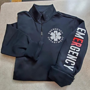 May include: Black zippered sweatshirt with a white star of life logo and the text "Emergency Department" on the front and "Emergency" on the sleeve.