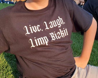May include: A black t-shirt with white text that reads "Live. Laugh. Limp Bizkit".