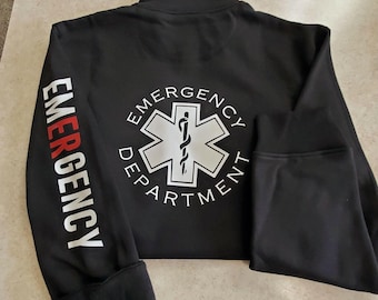 May include: Black zippered jacket with the words "EMERGENCY DEPARTMENT" in white lettering and a white star of life symbol on the back. The words "EMERGENCY" are printed in red on the left sleeve.