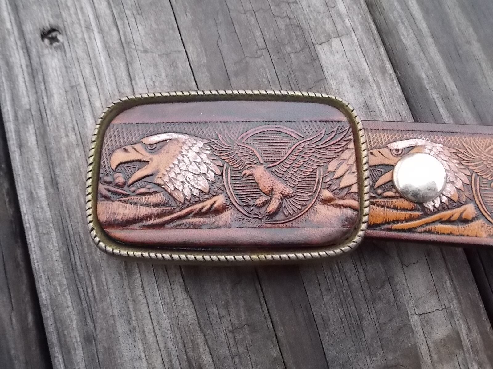 Leather belt with embossed eagles and leather and brass belt buckle
