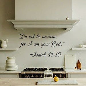 May include: A white kitchen with a wood countertop island and a white kitchen cabinet with a stainless steel range hood. The wall has a black vinyl decal with the quote "Do not be anxious for I am your God." - Isaiah 41:10