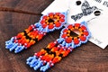 Violet and Orange Huichol Flower Earrings, Native American Beaded Earrings, Seed Bead Earrings, Huichol Beadwork, Native American Beadwork product logo