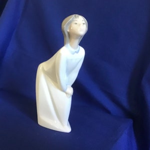 Genuine Lladro Figurine. No. 4873. Young Girl “Offering a Kiss”. Good Condition. Glazed Finish.  No chips or cracks.