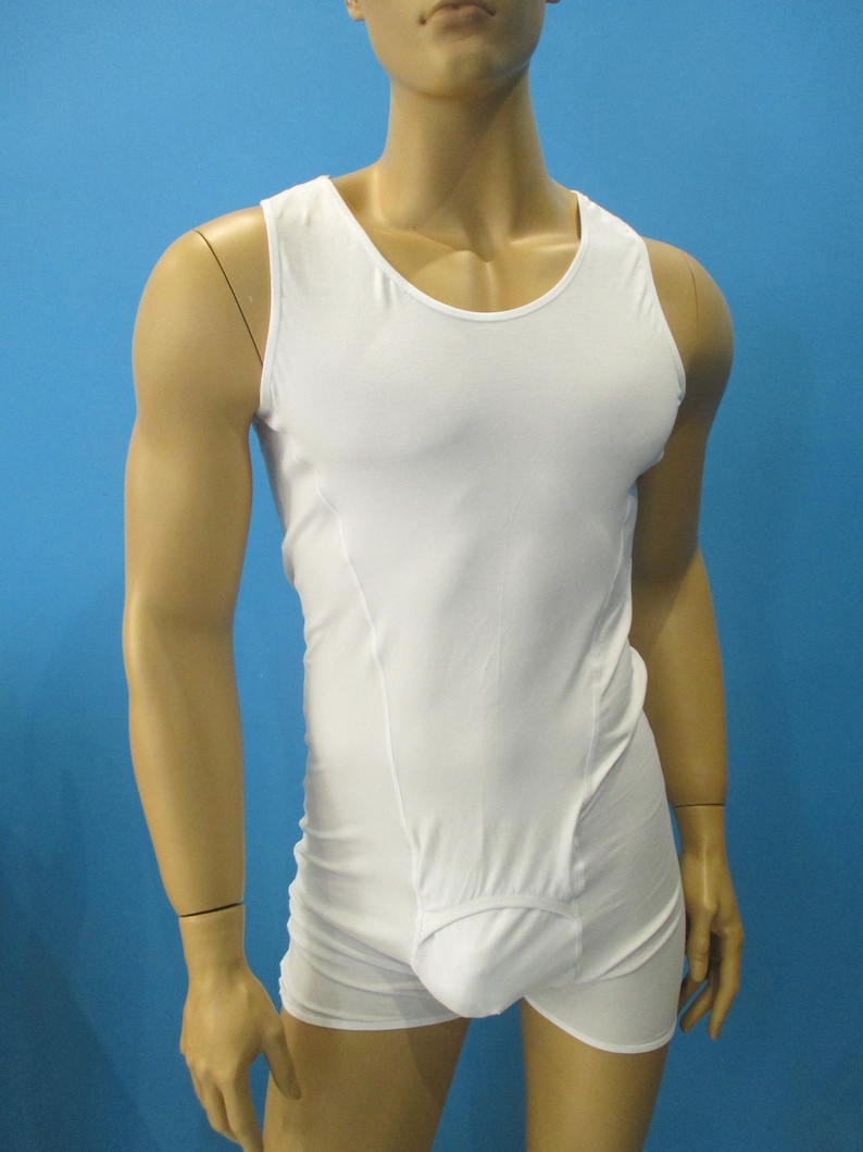 May include: White sleeveless undershirt with a built-in pouch. The undershirt is made of a smooth, stretchy fabric.
