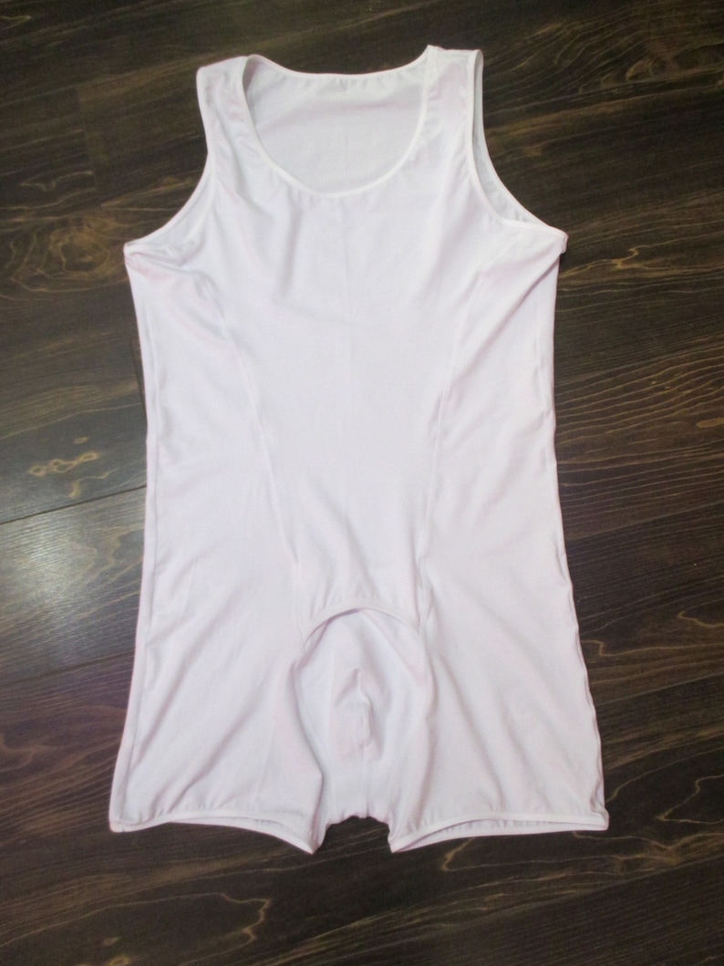 May include: White sleeveless undershirt with a scoop neck and a short leg opening.