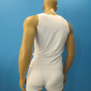 May include: A white sleeveless bodysuit with a scoop neck.