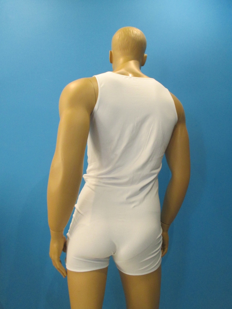 May include: A white sleeveless bodysuit with a scoop neck.