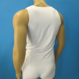 May include: White sleeveless bodysuit with a scoop neck. The bodysuit is made of a soft, stretchy fabric.