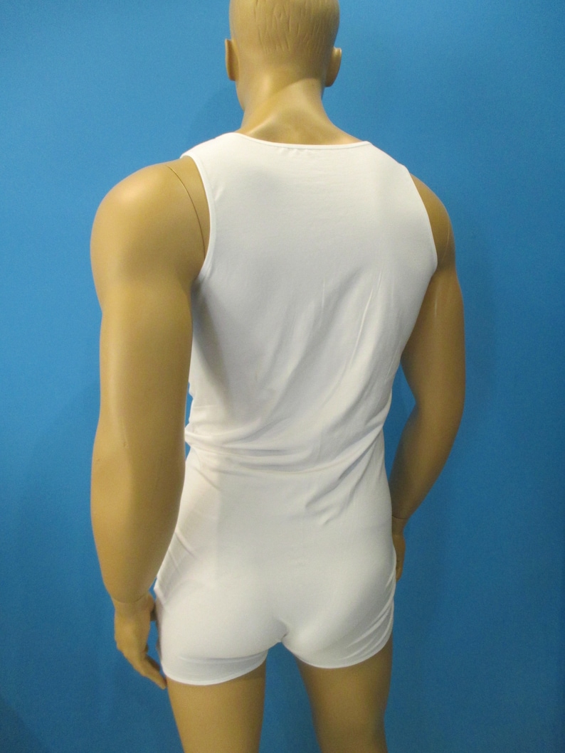 May include: White sleeveless bodysuit with a scoop neck. The bodysuit is made of a soft, stretchy fabric.